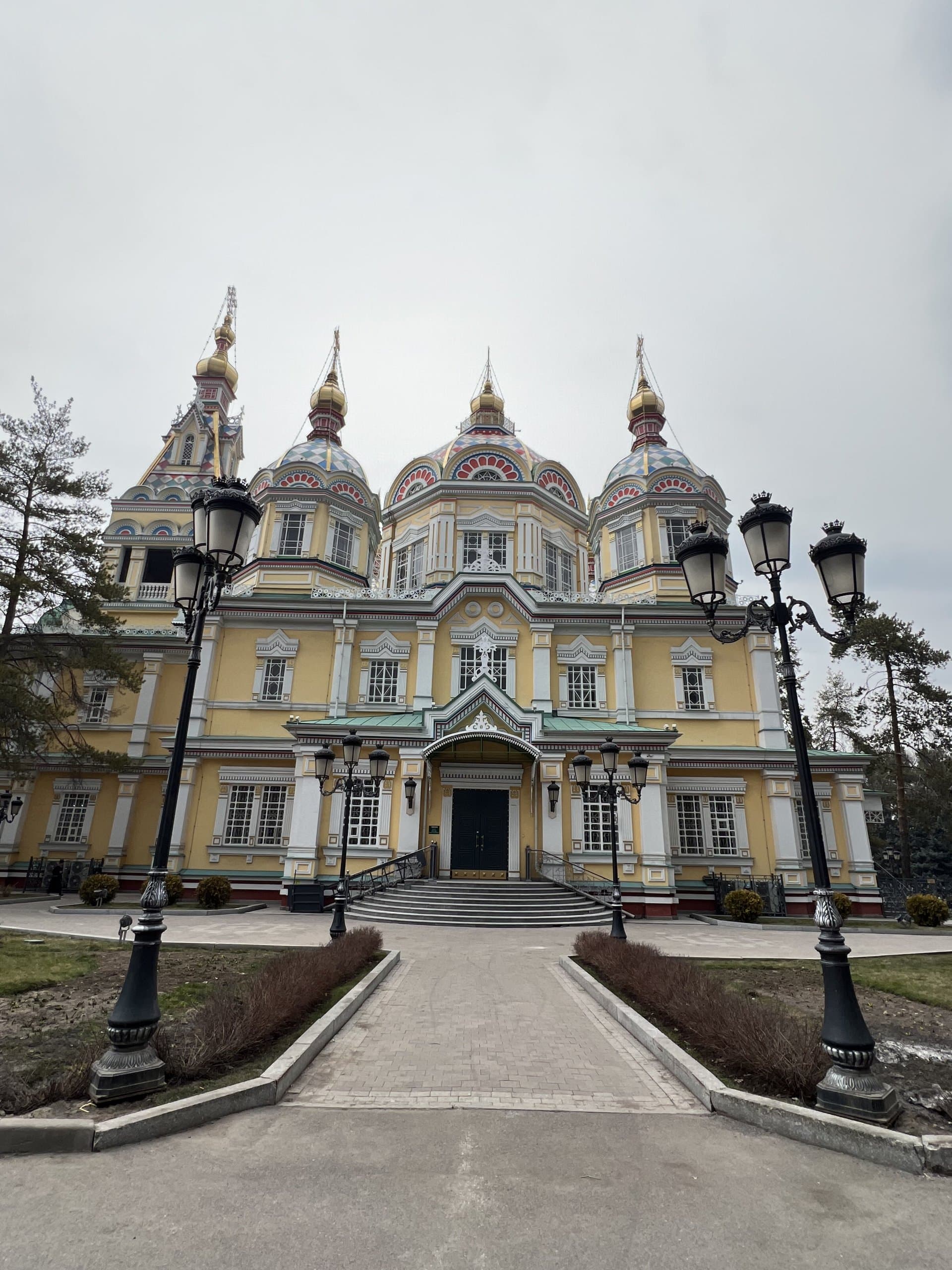 The wooden Ascension Cathedral in Almaty, with its pastel facade and golden domes